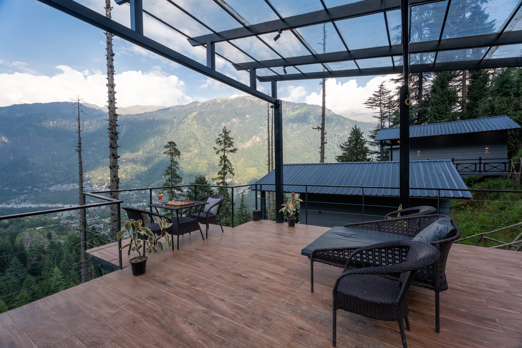 The covered café deck with tables and lounge seating above the valley.