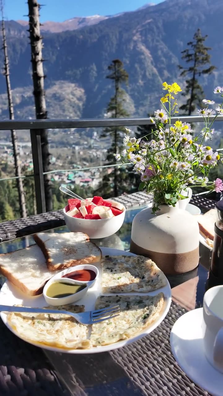 Wildflowers, a cafetiere and breakfast plates on the deck.